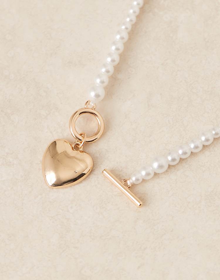 https://images.asos-media.com/products/asos-design-short-necklace-with-pearl-heart-detail-in-gold-tone/207909702-2?$n_750w$&wid=750&fit=constrain