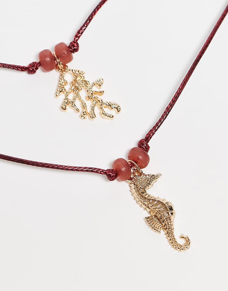 https://images.asos-media.com/products/asos-design-multi-row-red-cord-necklace-with-sea-life-charms-in-gold-tone/208395901-2?$n_750w$&wid=750&fit=constrain