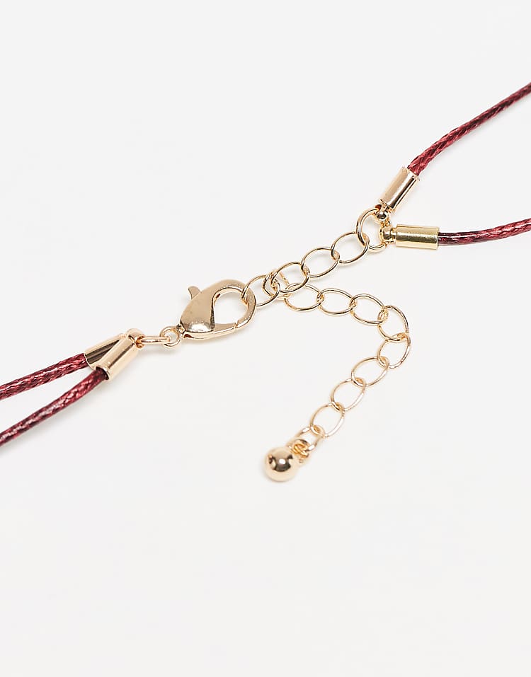 https://images.asos-media.com/products/asos-design-multi-row-red-cord-necklace-with-sea-life-charms-in-gold-tone/208395901-3?$n_750w$&wid=750&fit=constrain