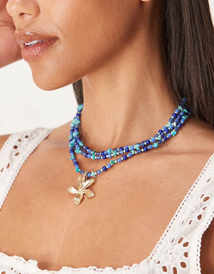 https://images.asos-media.com/products/asos-design-multi-row-necklace-in-blue-faux-stone-chipping-with-gold-tone-flower-pendant/208583071-1-blue?$n_750w$&wid=750&fit=constrain