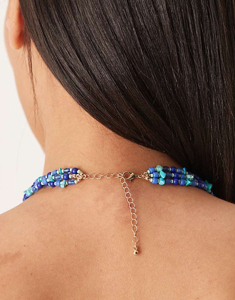 https://images.asos-media.com/products/asos-design-multi-row-necklace-in-blue-faux-stone-chipping-with-gold-tone-flower-pendant/208583071-3?$n_750w$&wid=750&fit=constrain
