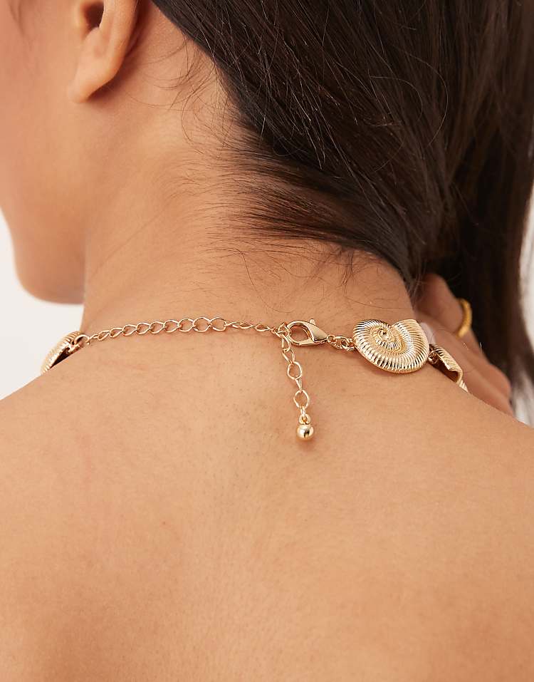https://images.asos-media.com/products/asos-design-choker-necklace-with-faux-shell-details-in-gold-tone/208788920-2?$n_750w$&wid=750&fit=constrain