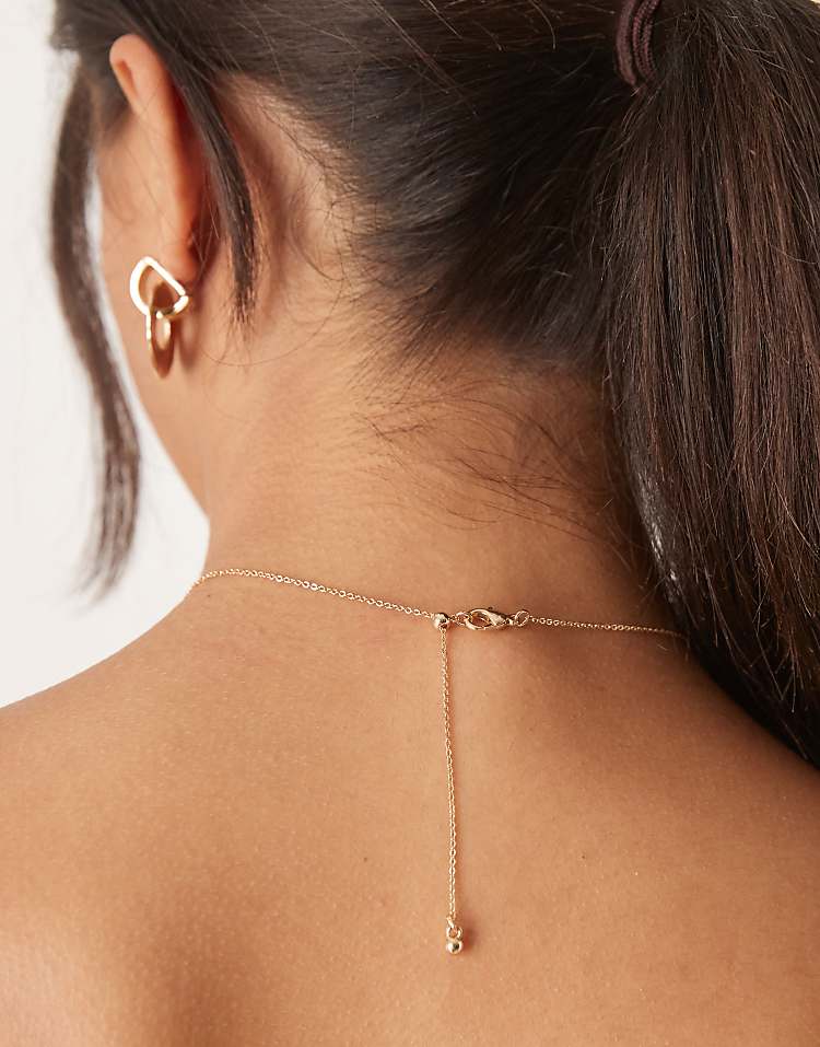 https://images.asos-media.com/products/asos-design-short-necklace-with-multi-charm-details-in-gold-tone/208932585-3?$n_750w$&wid=750&fit=constrain