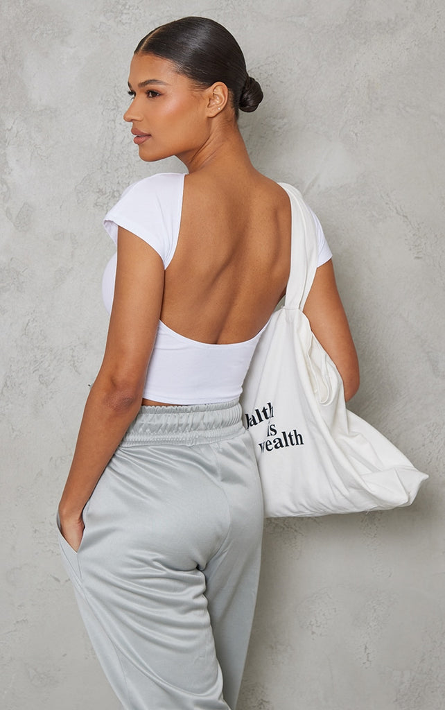 https://cdn-img.prettylittlething.com/3/b/d/d/3bddf6dcfa44a9a65e79bebe9d04d3923608ab0f_CNC9233_1_white_soft_rib_backless_top.jpg